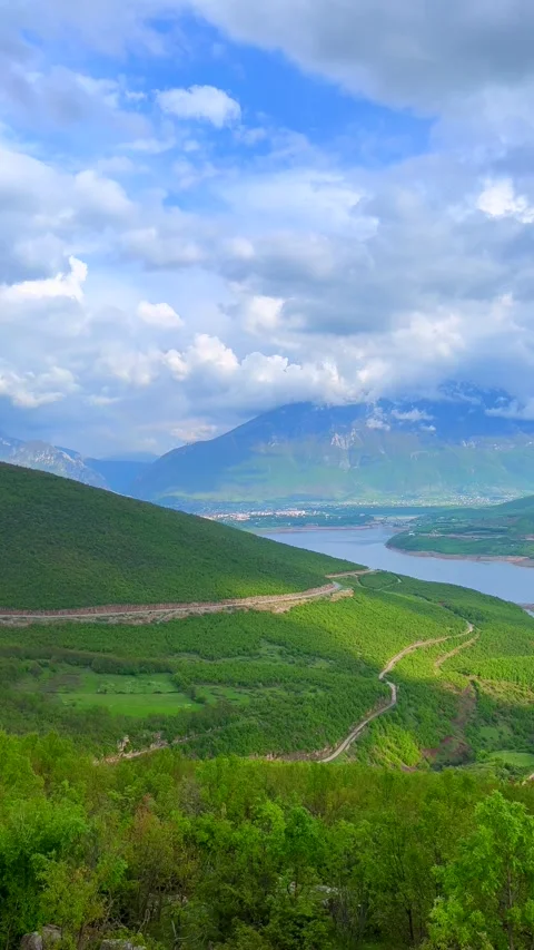 Panoramic View of Green Mountain Valley with River and Cloudy Sky Stock Footage 310210749