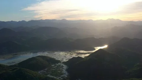 Panoramic view of green mountains in water of Skadar lake at sunset, Montenegro Stock Footage 154138464