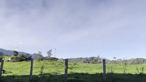 Panoramic view of green rural landscape with mountains and blue sky in Colom Stock Footage 342064022