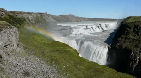 Panoramic view of the Gullfoss waterfall with a rainbow and tourists, Iceland Stock Footage 33795259