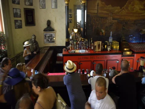Panoramic view to hall of well-known Cuban bar in Havana center. Bartenders pour Stock Footage 70917834