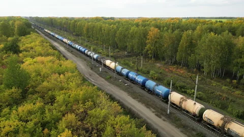 Panoramic view from the heights on the railroad with moving trains in the autumn Vídeos de archivo 254866497