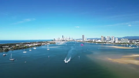 Panoramic view of a high-rise city towering above a scenic waterway and Stockbeeldmateriaal 282359212