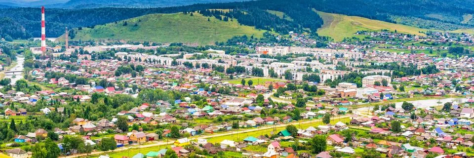 Panoramic view from hill to plain with small town in summer cloudy day. Pictu Stock Photos