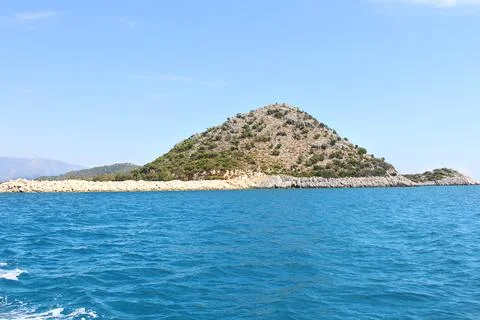 Panoramic view of hillside mountain with trees, stone breakwater Stock Photos