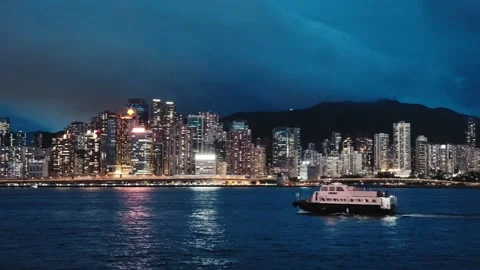 A panoramic view of Hong Kong's skyline at night from Victoria Harbour. The city Stock Footage 338280353