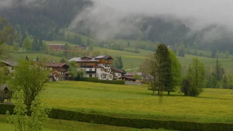 Panoramic view of a hotel surrounded by green trees and mountains in distance. Stock Footage 300013338