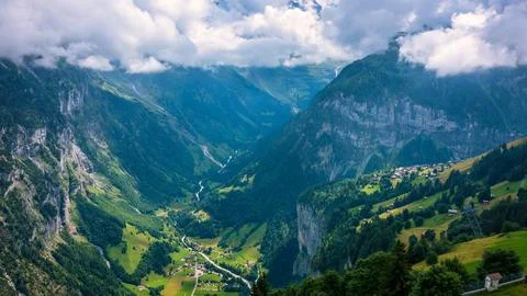 Panoramic view of idyllic mountain scenery in the Alps with fresh green mea.. Stock Photos