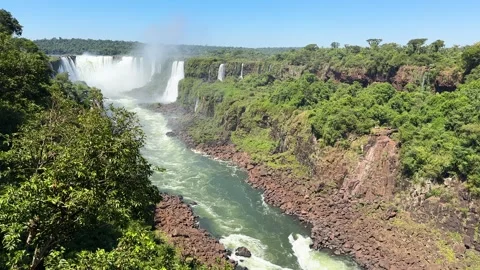 Panoramic view of Iguazu Falls cascading into the river Stock Footage 341004519