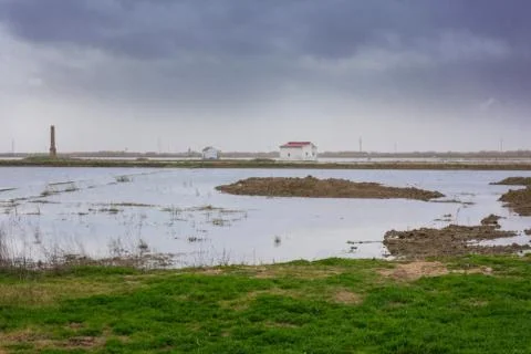Panoramic view of an isolated house in the middle of a dry lagoon surface ground Stock Photos