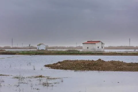 Panoramic view of an isolated house in the middle of a dry lagoon surface ground Stock Photos