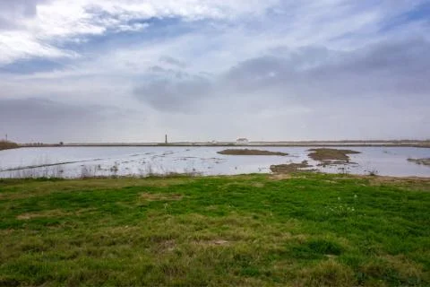 Panoramic view of an isolated house in the middle of a dry lagoon surface ground Stock Photos