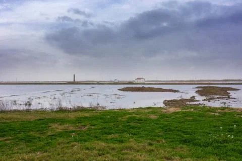 Panoramic view of an isolated house in the middle of a dry lagoon surface ground Stock Photos