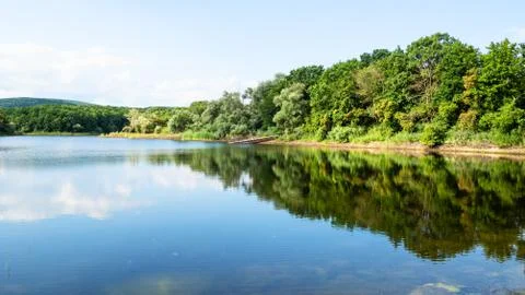 Panoramic view of karst lake in forest in summer Stock Photos