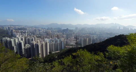 Panoramic view of Kowloon cityscape from high train on hill side Stock Footage 309436745