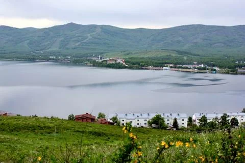 Panoramic view. A lagoon with a clean mountain lake in the midst of majestic 库存照片