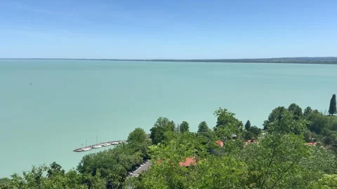 Panoramic view of Lake Balaton with hillside village and waterfront pier in Hung Stock Footage 339012448