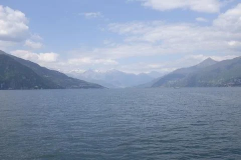 Panoramic view of Lake Como on a cloudy day with the Alps in the Stock Photos