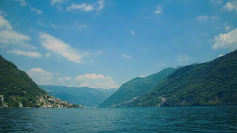 Panoramic view of Lake Como framed by mountains and lush green hills Stock Footage 325545536