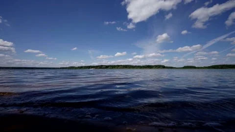 Panoramic view of the lake surrounded by forest, with perfectly clear sky and Stock Footage 287622402
