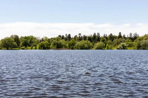 Panoramic view of lake surrounded by forest. Natural landscape. Stock Photos