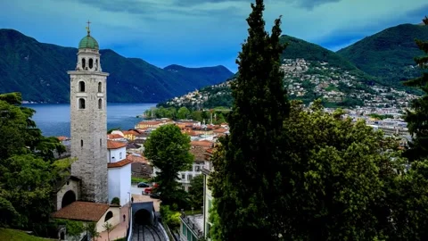Panoramic View of Lakeside Town with Bell Tower and Funicular Railway Stock Footage 310705638