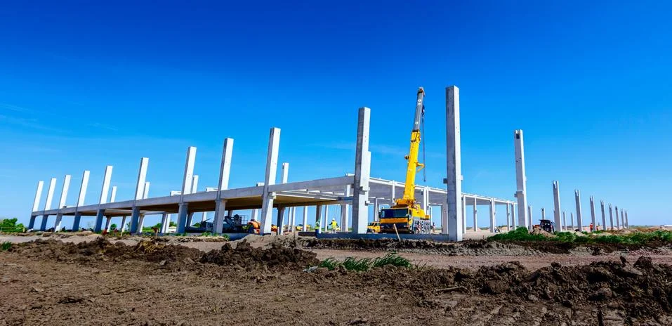 Panoramic view on landscape transform into urban area with machinery, people Stock Photos