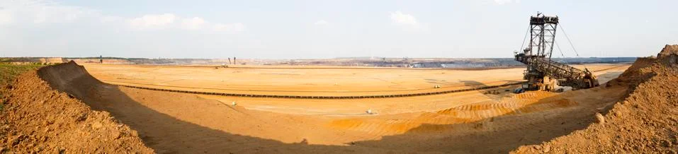 Panoramic view of a large coal pit mine with a giant bucket-wheel excavator,  Stock Photos