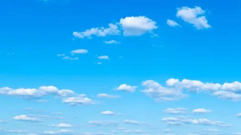 Panoramic view of light cumuli clouds in blue sky Stock Photos
