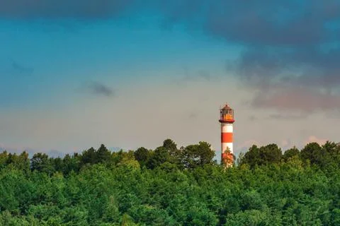 Panoramic view of lighthouse at dusk sky background near sea Stock Photos