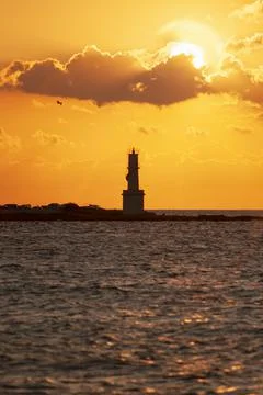 Panoramic view of a lighthouse on the sea at sunset Foto stock