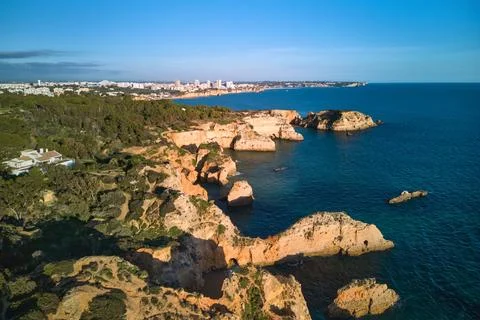 Panoramic view of the limestone cliffs and Portimao city, Portugal Stock Photos