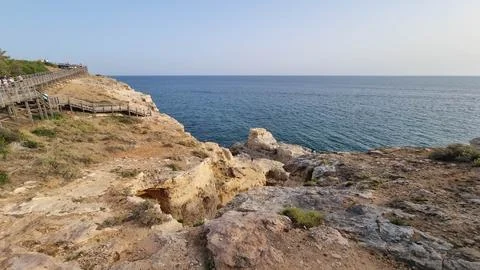 Panoramic view of limestone cliffs and Mediterranean coastline at golden hour Фото