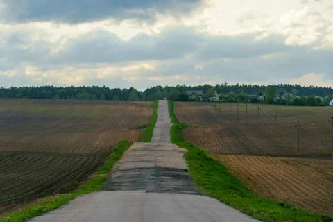 Panoramic view of a long empty asphalt road in a hilly area. The empty windin Stock Photos