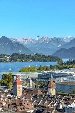 Panoramic view of Lucerne city with lake and mountains, paraglider in the sky Stock Photos