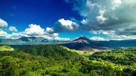 Panoramic View of Lush Green Mountains and Volcanic Landscape under Blue Sky Stock Footage 308281676