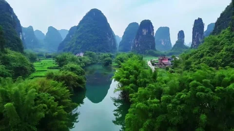 Panoramic View of Lush Karst Mountains Reflected in Tranquil River Guilin Stock Footage 339040574
