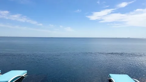 Panoramic view of a luxury infinity pool with rippling blue water Stock-Footage 335829247