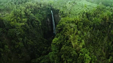 Panoramic view of a majestic waterfall in the green forest at dawn with blind Stock Photos