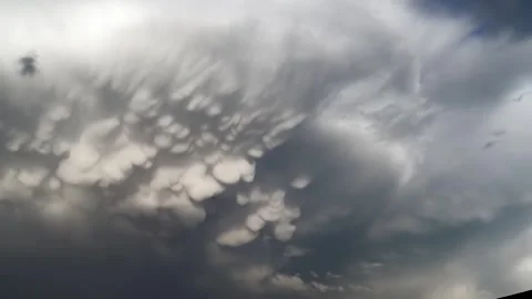 Panoramic view of mammatus clouds forming in blue sky, storm weather pattern Stock Footage 339467783