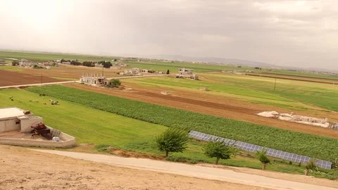 Panoramic view, Marj Dabiq plains near Aleppo Syria shows farmland, solar panels Stock Footage 320761963