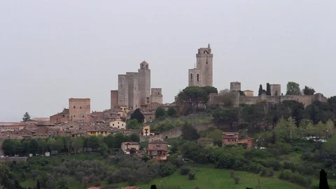 Panoramic view of the medieval town of San Gimignano under the gray sky Stock Footage 107004660
