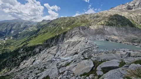 Panoramic view of the melting rhone glacier creating a glacial lake and a river Stock Footage 340919695