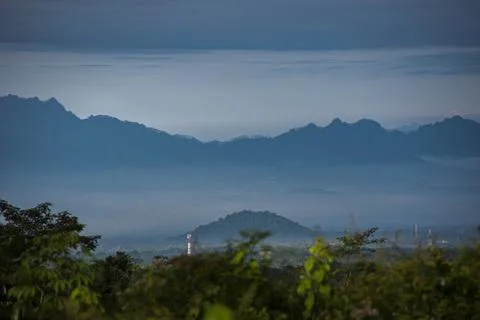 Panoramic view of misty mountain formations in the morning Stock Photos