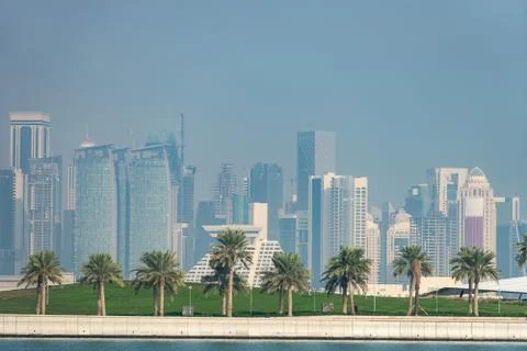 Panoramic view of modern skyline of Doha with Palms foreground. Concept of Stock Photos