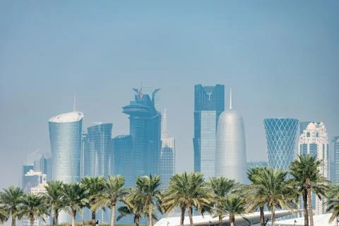 Panoramic view of modern skyline of Doha with Palms foreground. Concept of Stock Photos