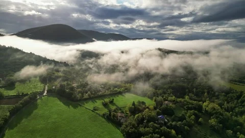 Panoramic view of the morning thick wavy fog hanging over the forest at sunrise Stock Footage 291934858