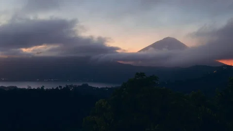 Panoramic View of Mount Abang And Lake Batur at Sunrise, Rolling Clouds Drift Ac Stock Footage 337015734