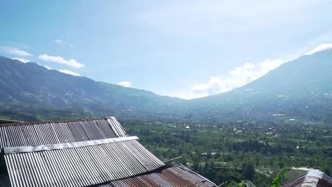 Panoramic view of Mount Merapi and Mount Merbabu with rice fields in front of it Stock Footage 233229011