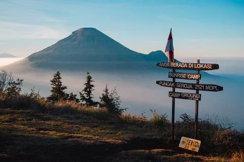 A panoramic view of Mount Sindoro set against a golden-blue sky at sunrise Photos
